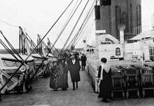 Some Passengers taking a stroll on deck of the Titanic.